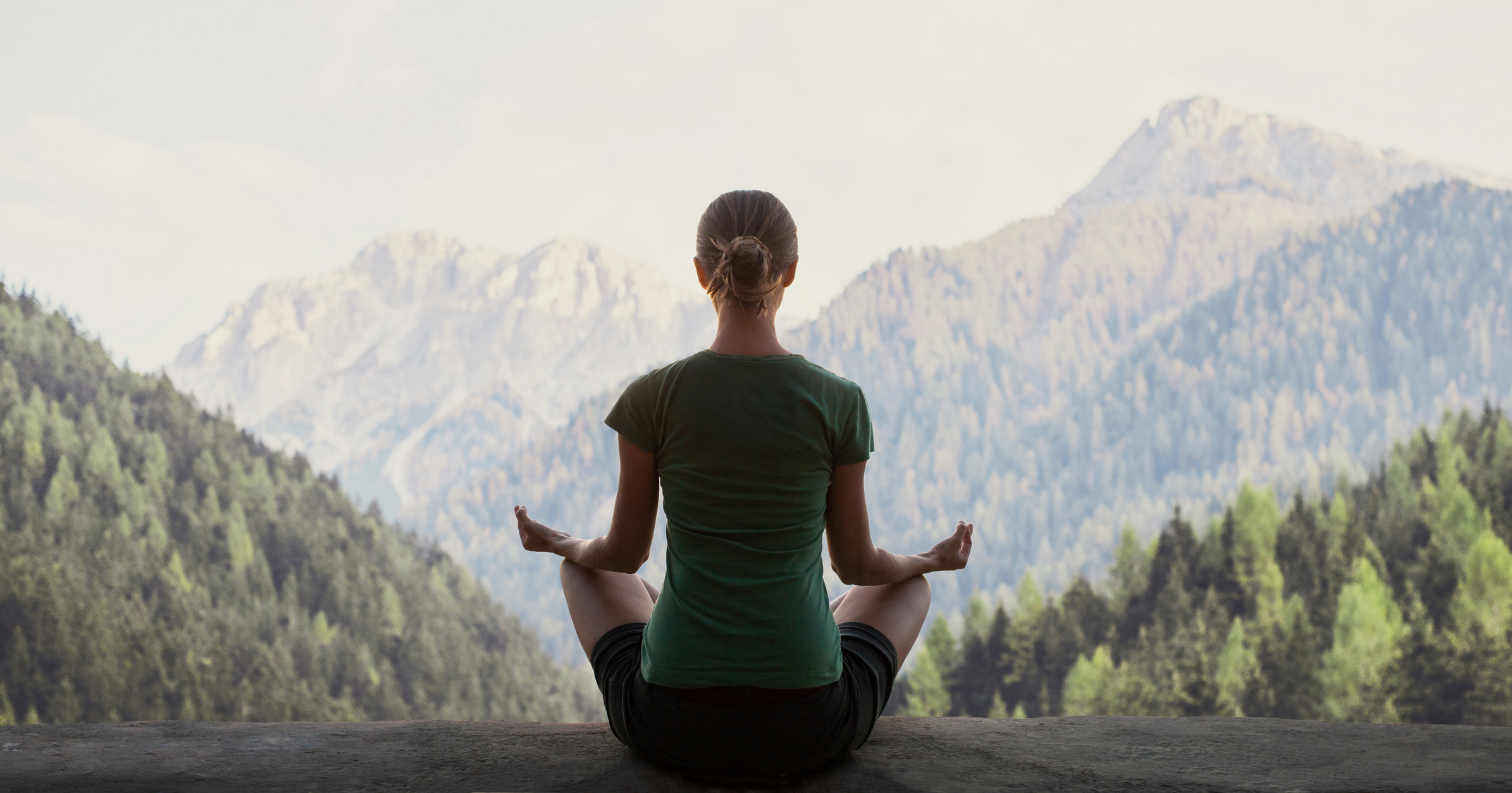 Woman practicing yoga in a mountains. Meditation and relaxation concept