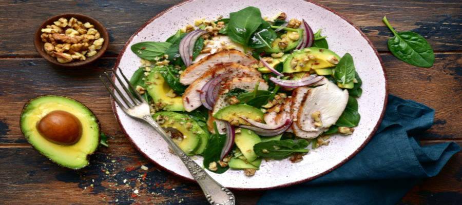 Spinach salad with grilled chicken fillet, avocado and walnuts