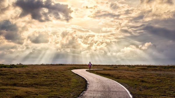 Concept image of a man walking along a path
