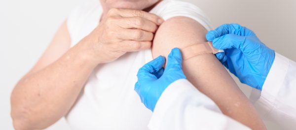 Elderly Woman with bandage after received vaccine. Vaccination and Immunization for Influenza, Herpes Zoster, Tetanus, Covid 19 booster, Dengue, Encephalitis, Rabies, Pneumococcal, IPD, RSV Vaccines