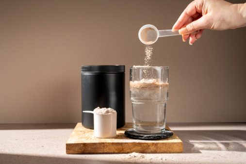 Protein shake and chocolate protein powder in a scoop, Sports nutrition